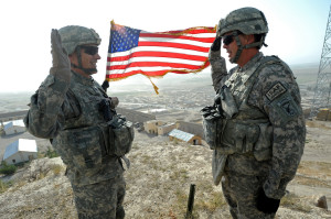 U.S. Air Force Lt. Col. Andy Veres, left, Provincial Reconstruction Team Zabul commander, re-enlists Master Sgt. James Sandifer, Forward Operating Base Smart mayor, on top of Alexander's castle in Qalat City, Afghanistan, July 7.