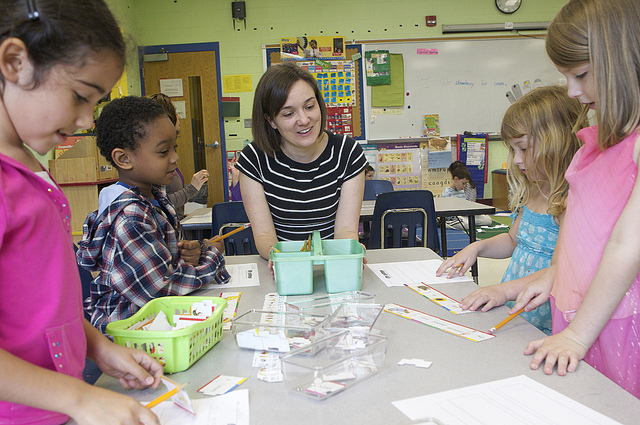 An elementary school teacher engages her students in a classroom.