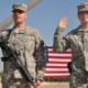 Two soldiers with their right hands raised take the United States Armed Forces Oath of Enlistment.