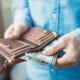 A businessman puts money into the breast pocket of his jacket