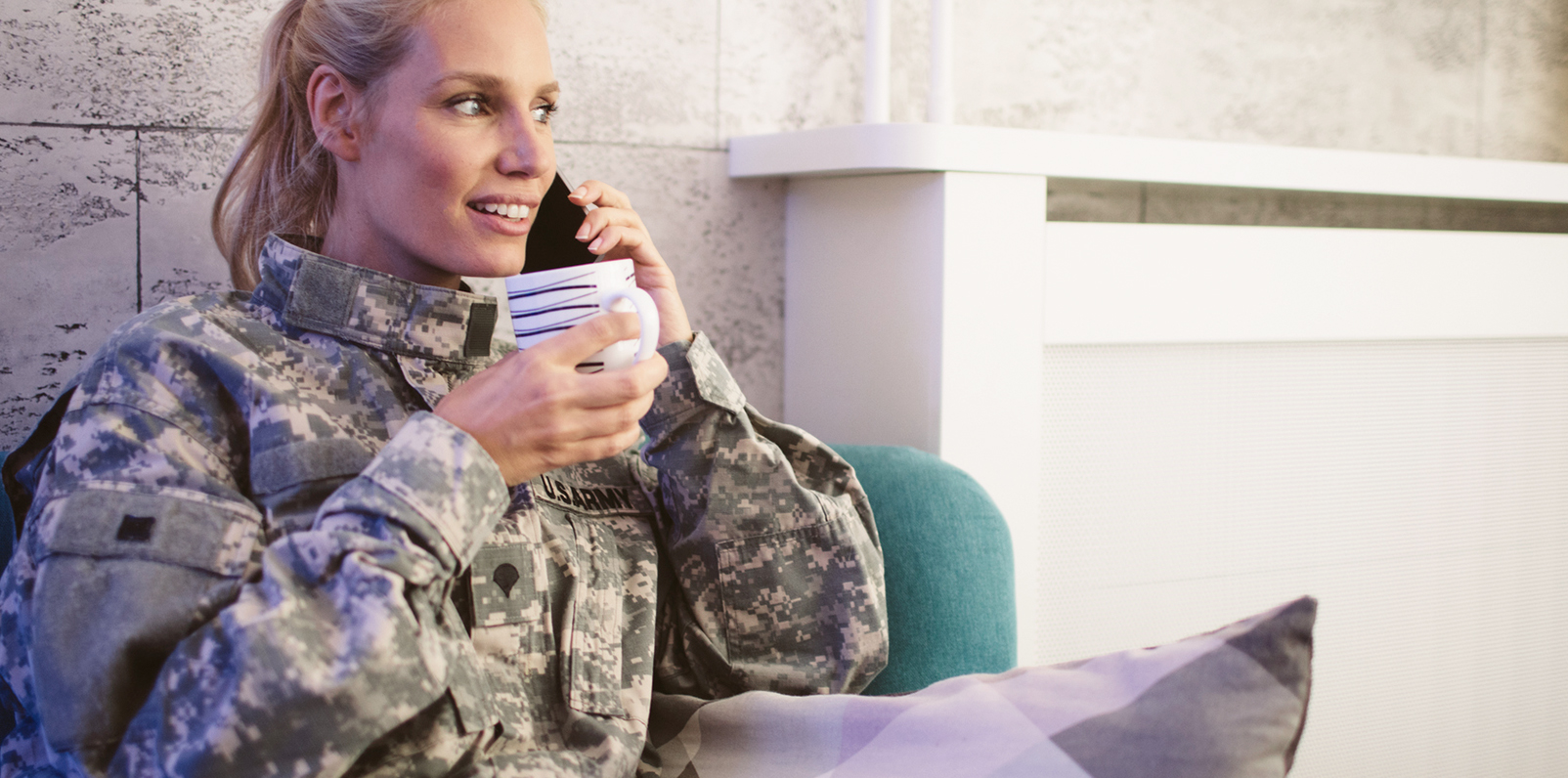 Military service woman on a cell phone learning about an exclusive offer.