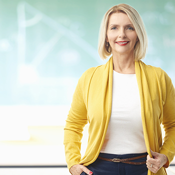 A teacher in front of a blackboard. 94% of teachers will go out of their way to shop at companies that provide teacher discounts.