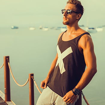 Young man wearing a tank top he purchased using a gated exclusive offer for college students.