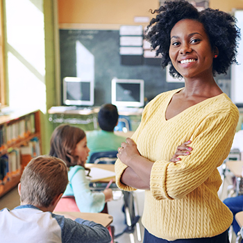 A smiling teacher in her classroom. Eighty-eighty percent of teachers said they actively search for companies that offer a teacher discount.