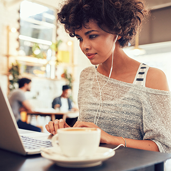 A young woman watches a streaming media service she subscribed to with a gated student offer for college students.