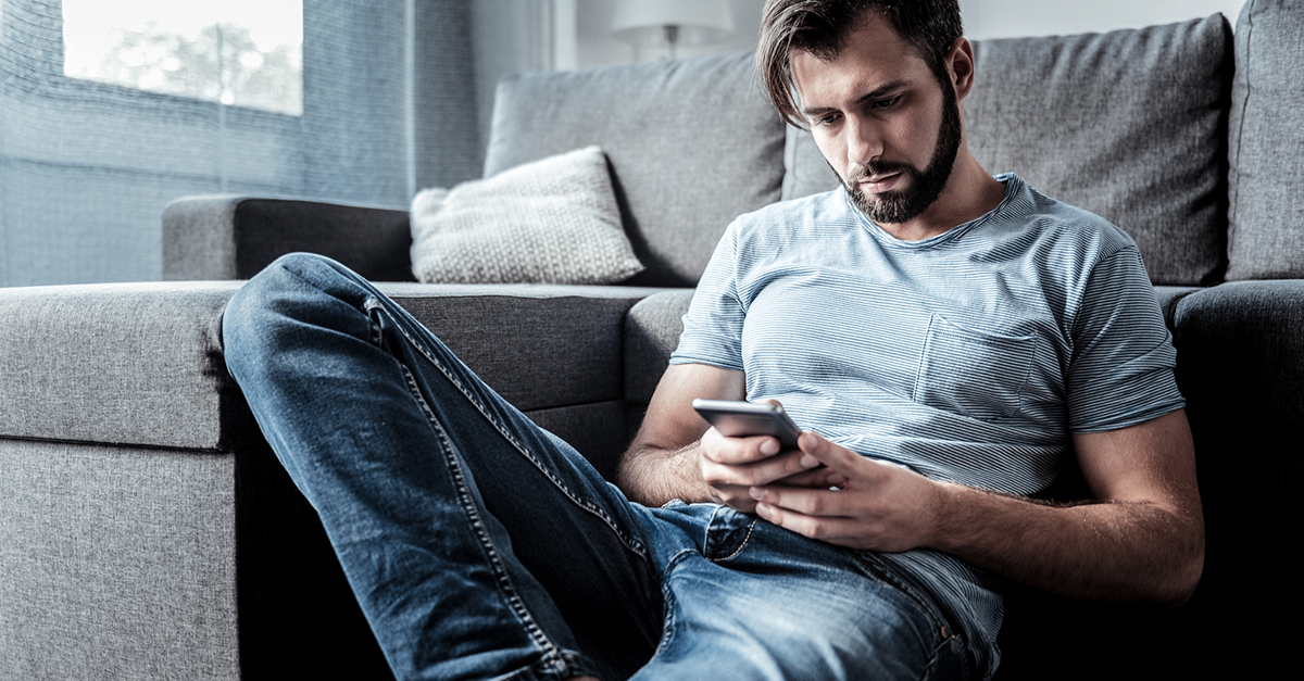 A consumer shopping on his iPhone worrying about digital marketing and privacy.