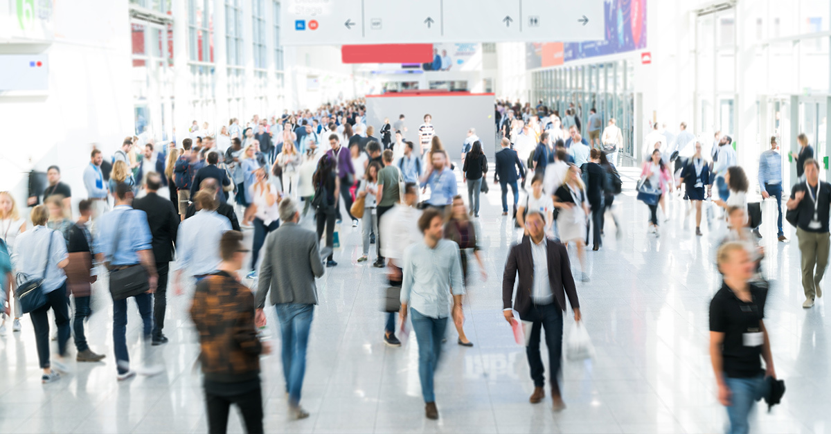 A shopping mall filled with people. Retailers greatest customer acquisition challenge is standing out from their competitors.