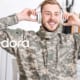 A smiling soldier listens to Pandora. The streaming media company is acquiring loyal subscribers by marketing to the military with exclusive discounts on their premium plan.