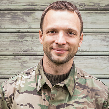 An active-duty soldier smiling.