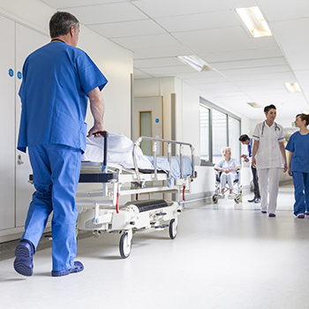 Nurses at work in a hospital corridor. Marketing to Nurse with gated offers is a powerful way to acquire new customers.