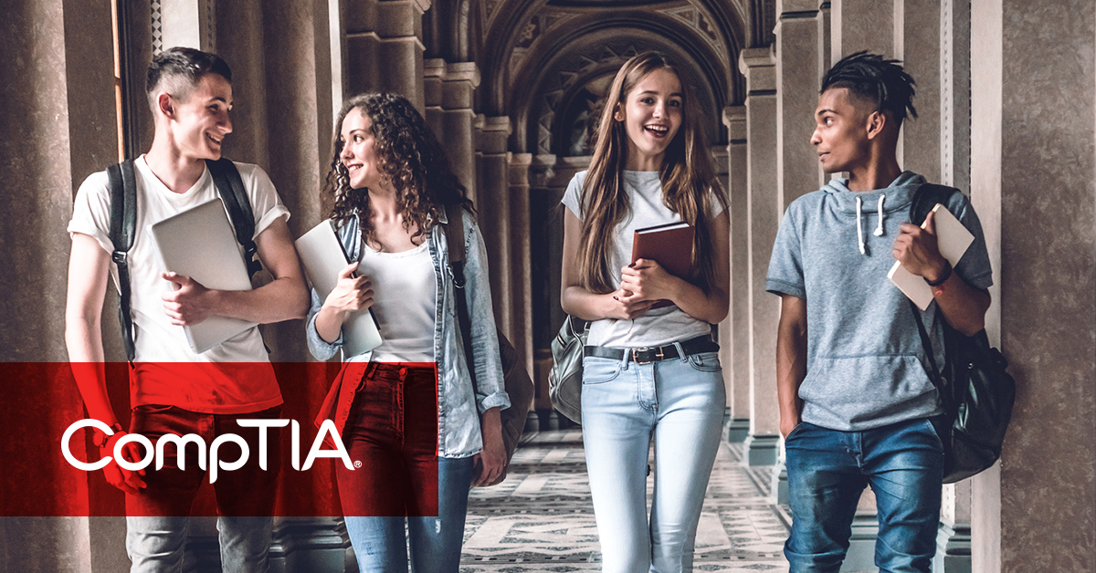 Happy college students walking down a corridor in a stately campus building.