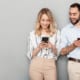 A man and woman verifying a personalized offer on their cell phones, underscoring the importance of customer verification for brands.