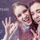 Two female Gen Z Comcast customers smiling because the company's creative way to market to college students included Amazon Music and HBO, too.