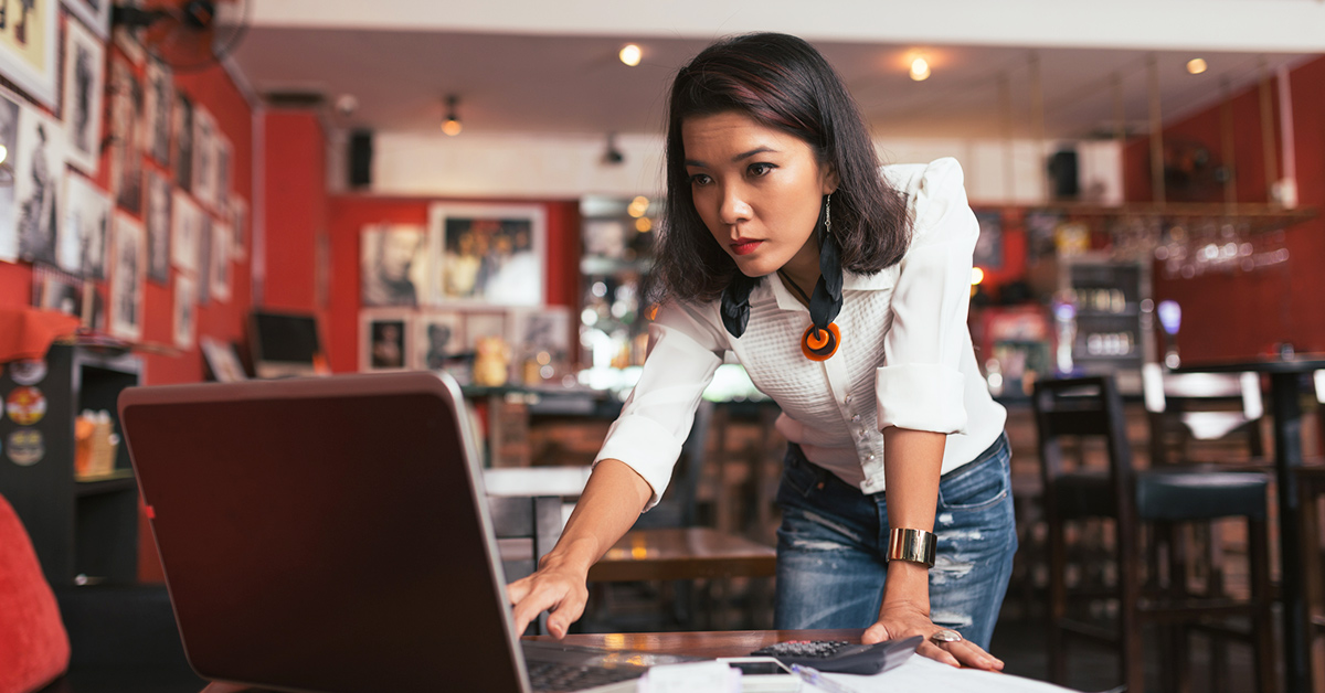 A female marketer in front of her laptop, concerned about the rising cost of her segmentation strategy.