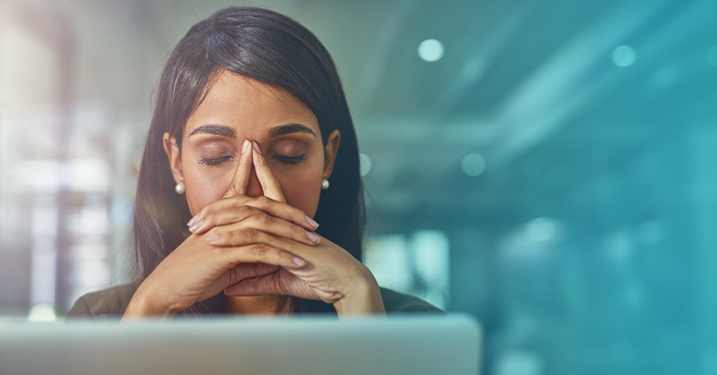 A female marketer in front of her laptop, frustrated by the limitations of affiliate-based verification.