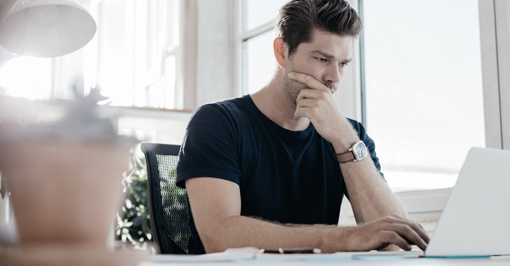 A male marketer in front of his laptop, worried about his unprotected personalized offer.