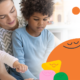 A woman working with two young students in an ad representing Headspace's customer acquisition strategy for teachers.
