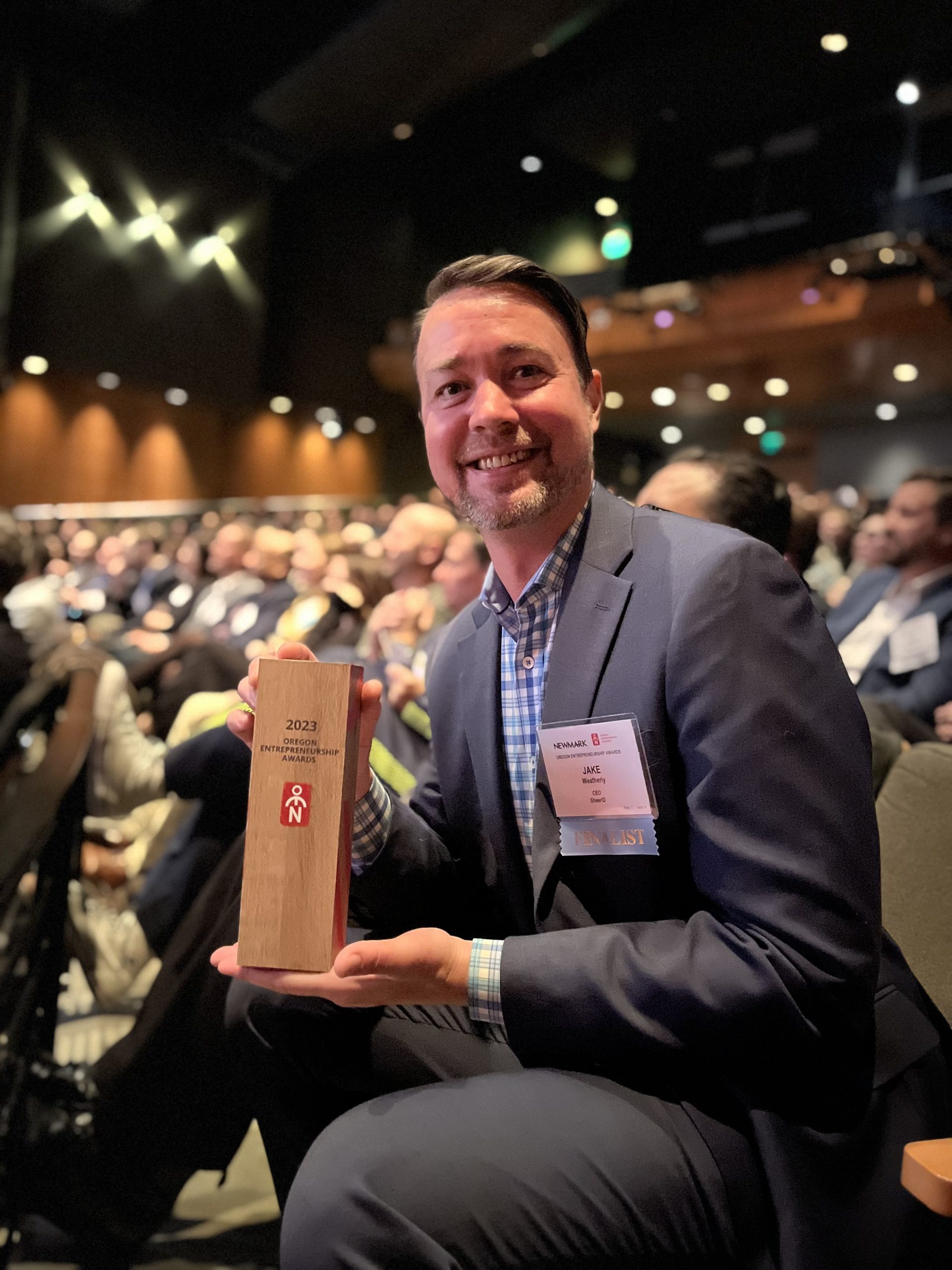 Jake Weatherly, former SheerID CEO holds award for 2023 Oregon Entrepreneurs Awards