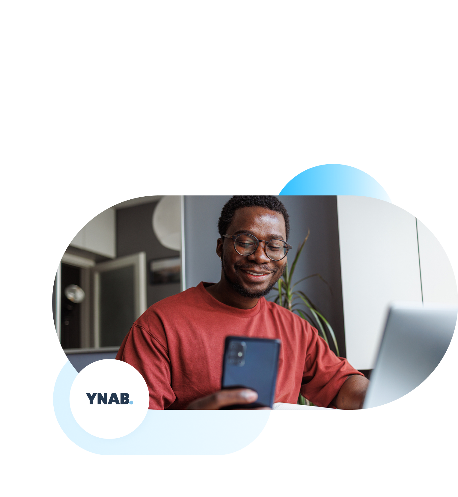 YNAB branded image of young man smiling at phone.