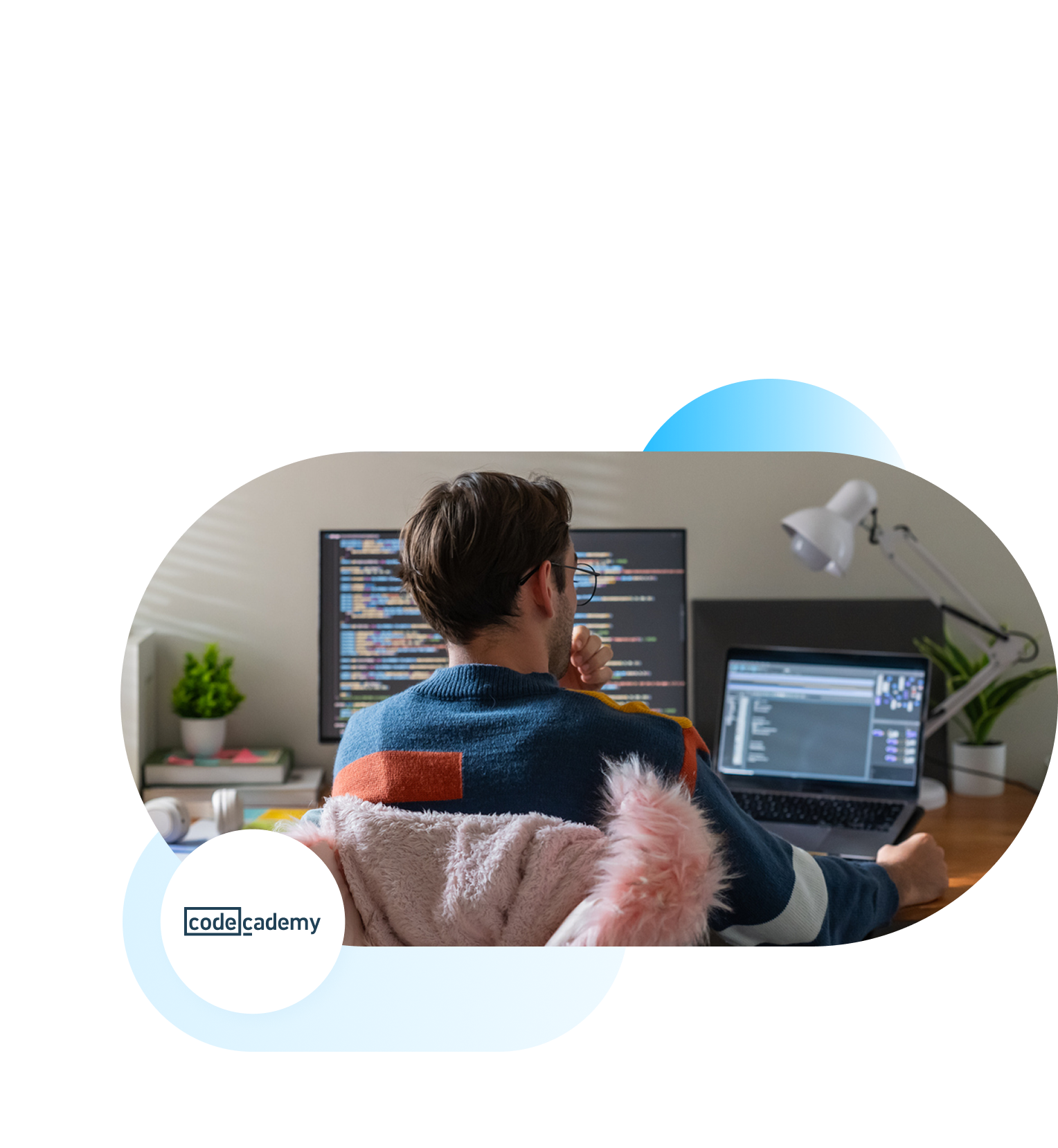 Software developer working on two screens.