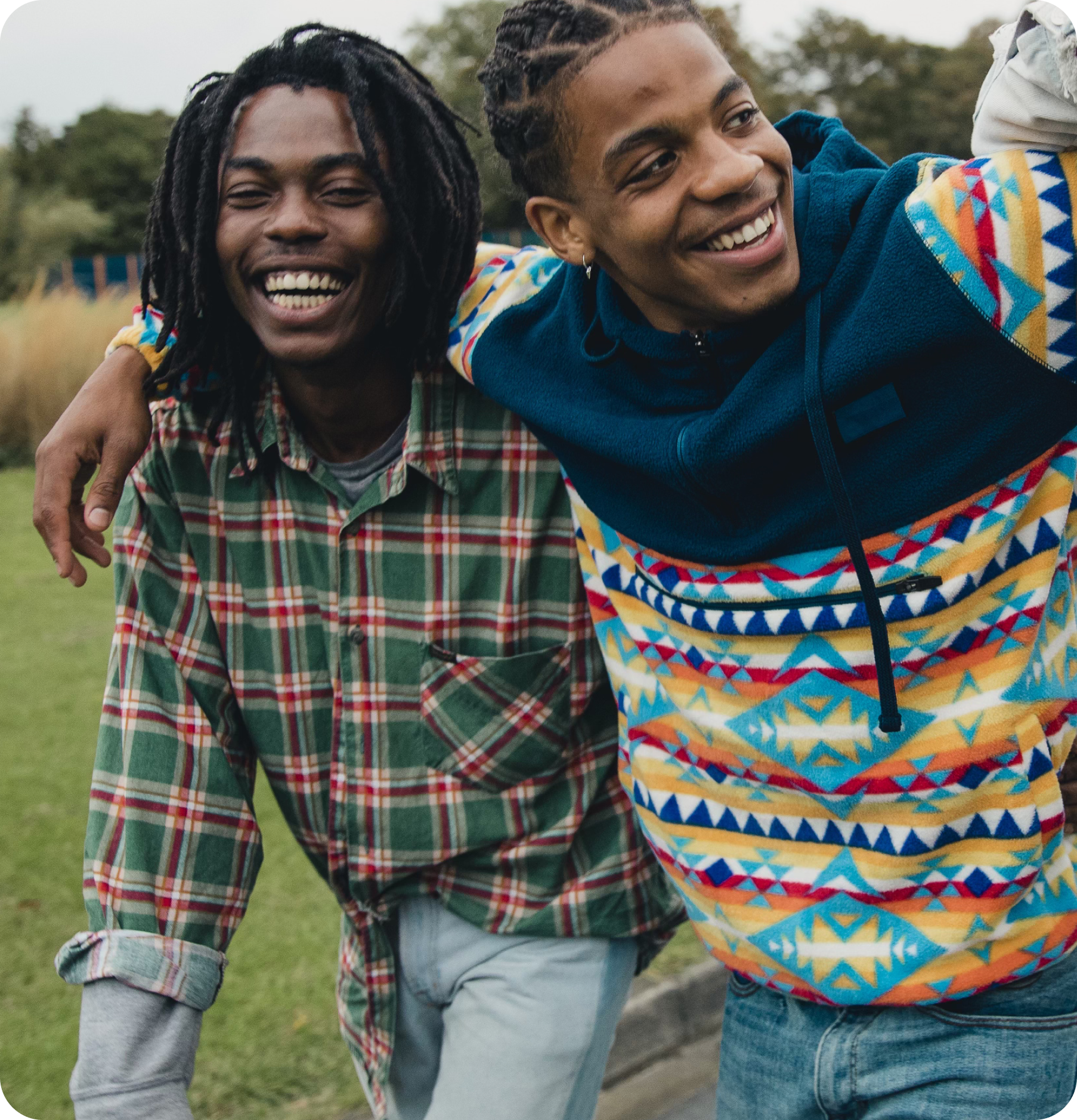 Friends in fall attire laughing together.