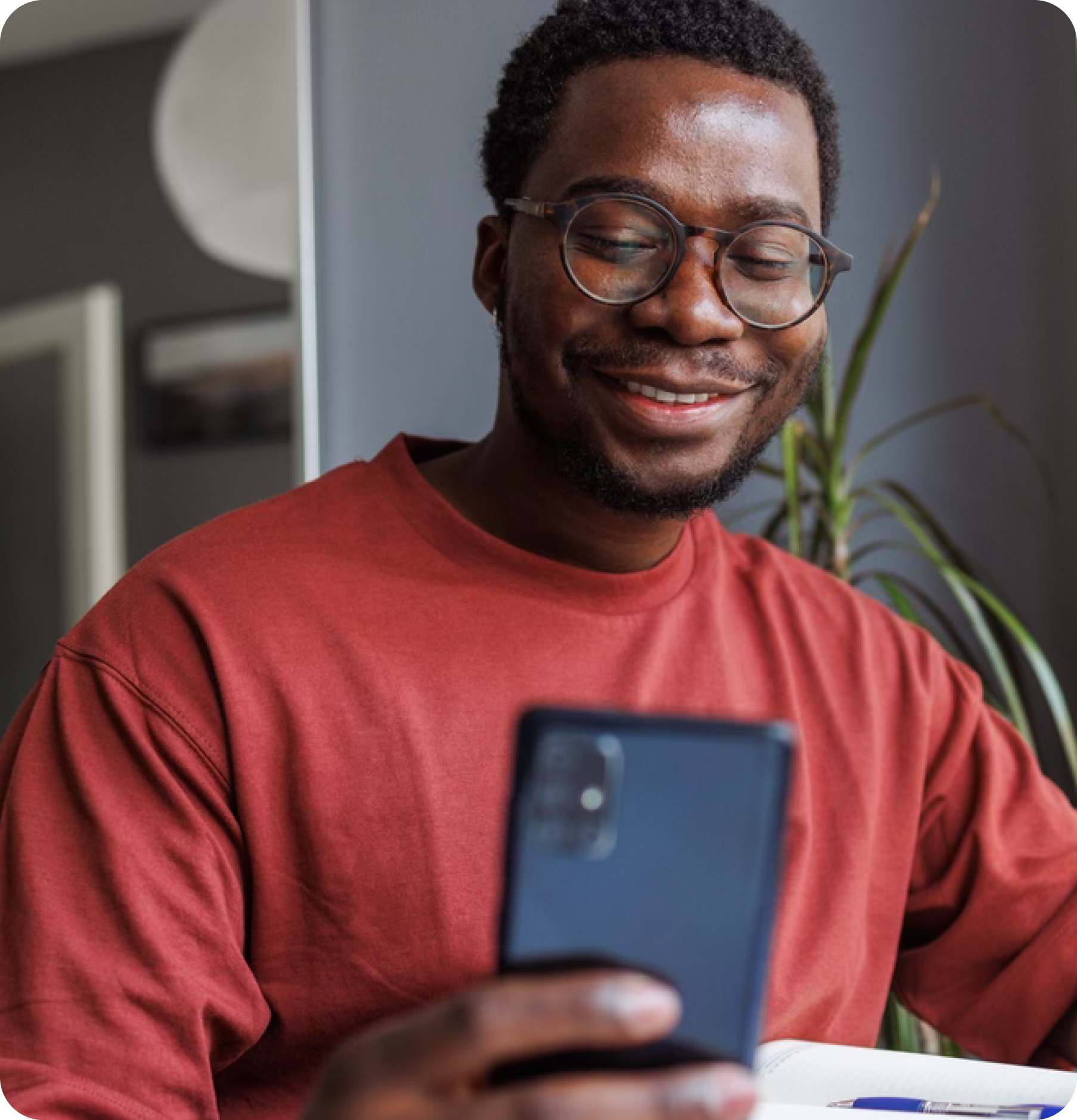 Man smiling at phone.