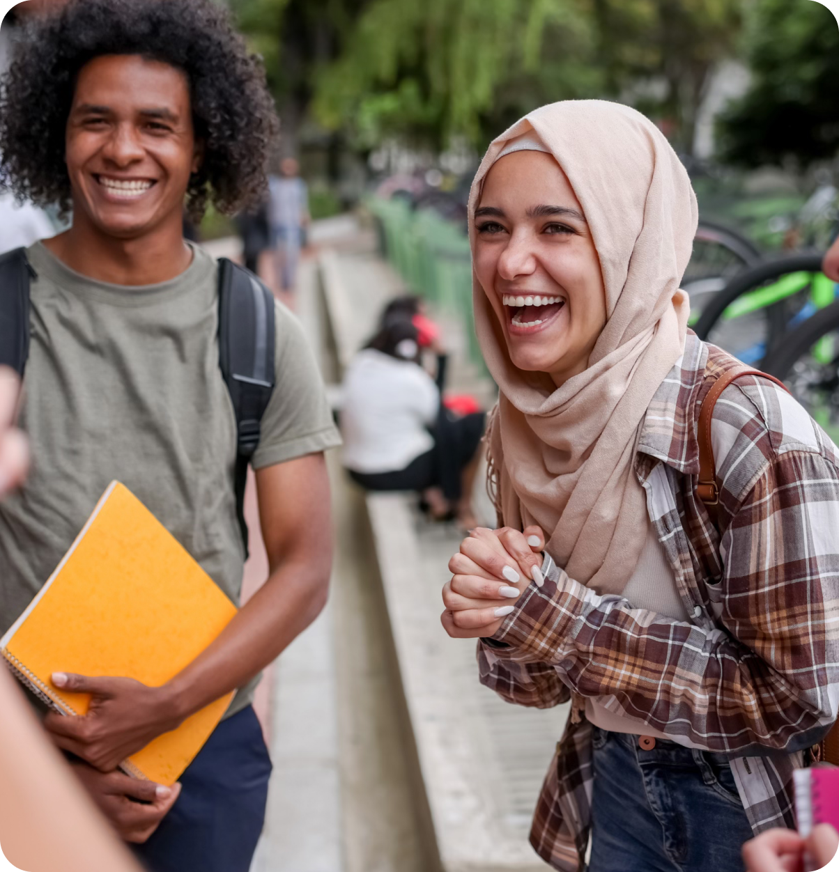 Woman in hijab smiles with friends.