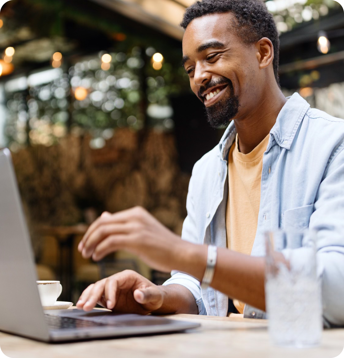 Man laughing and typing on computer.