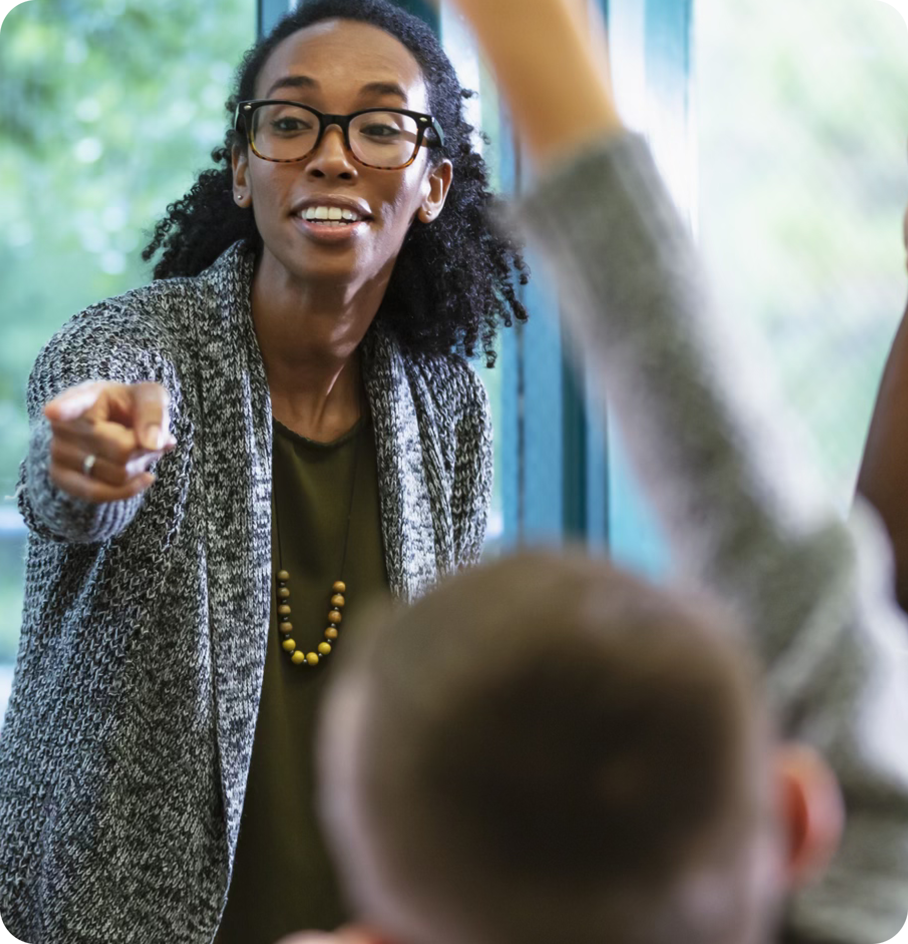 Teacher calls on student raising hand.