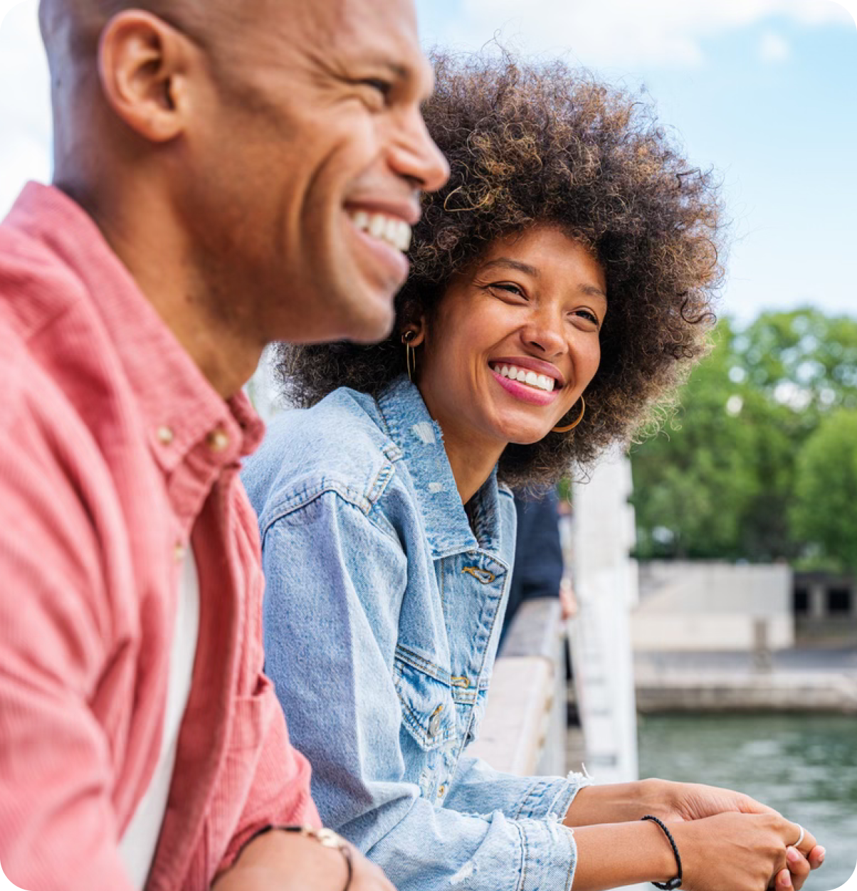 Smiling young adults at balcony.