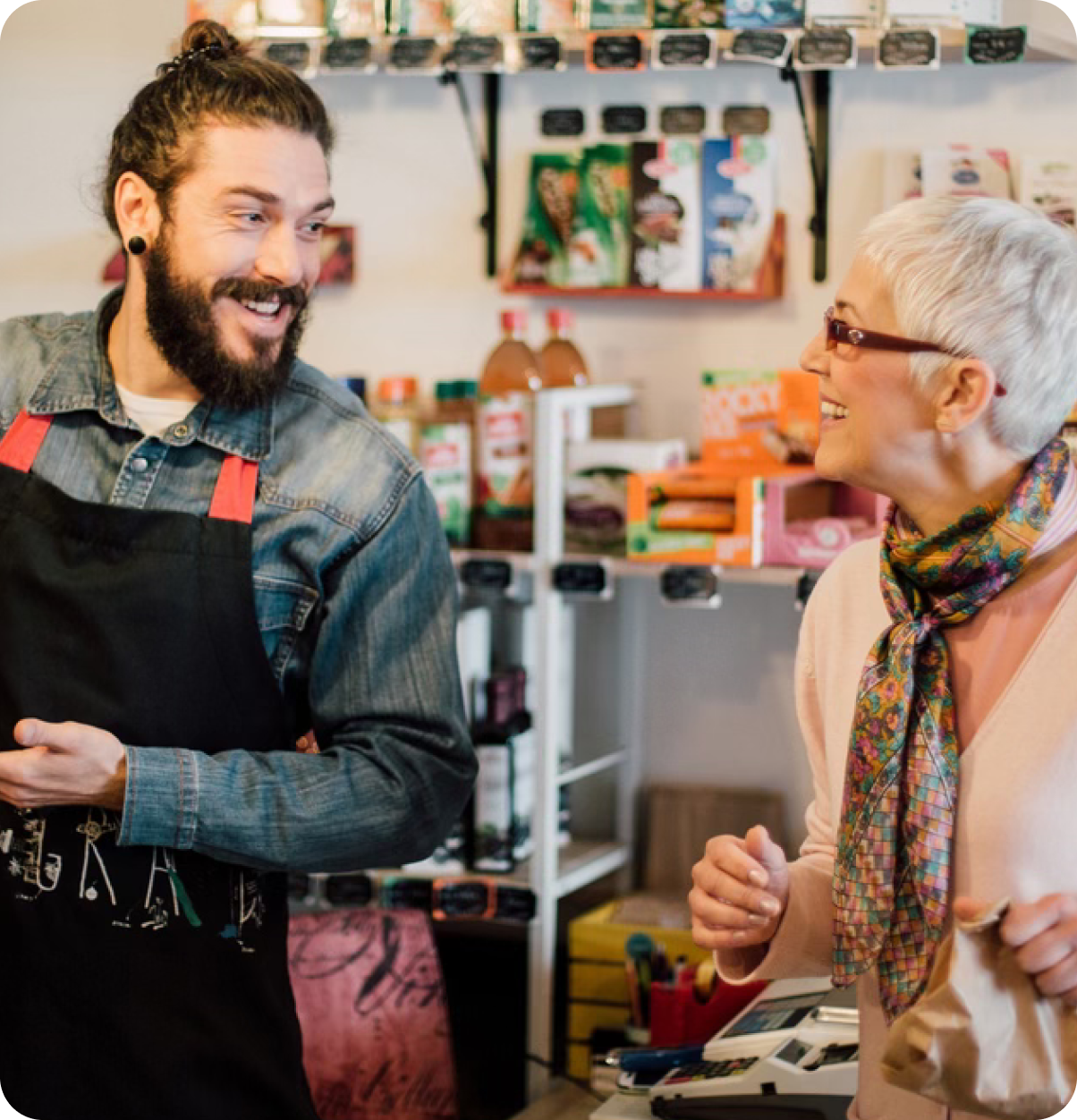 Older adult and retail merchant conversing.