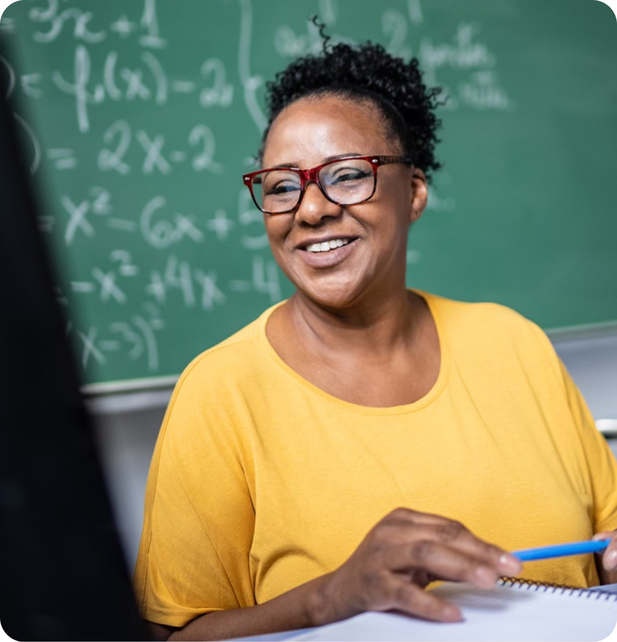 Smiling teacher in classroom.
