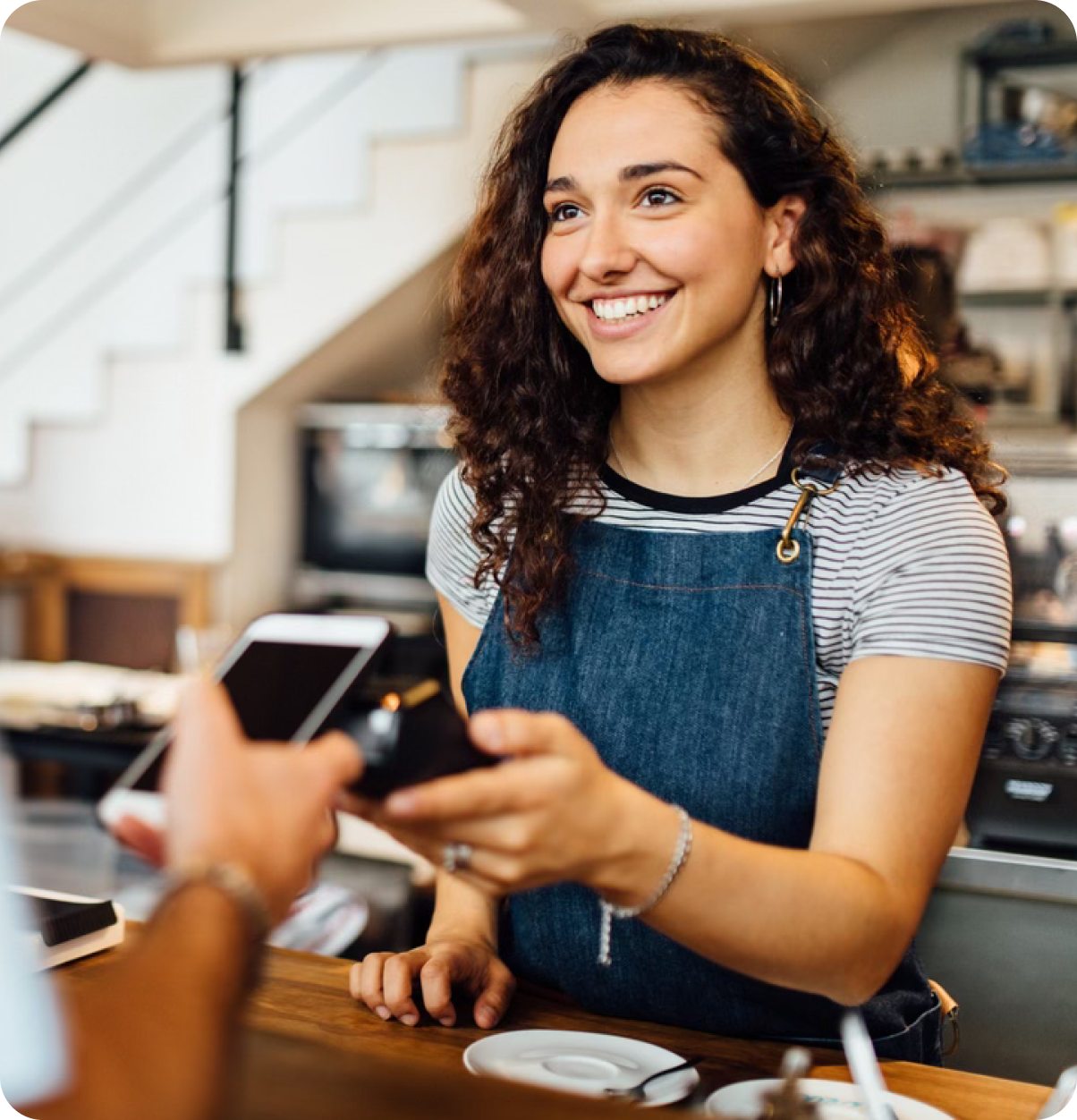 Woman making contactless transaction at checkout.