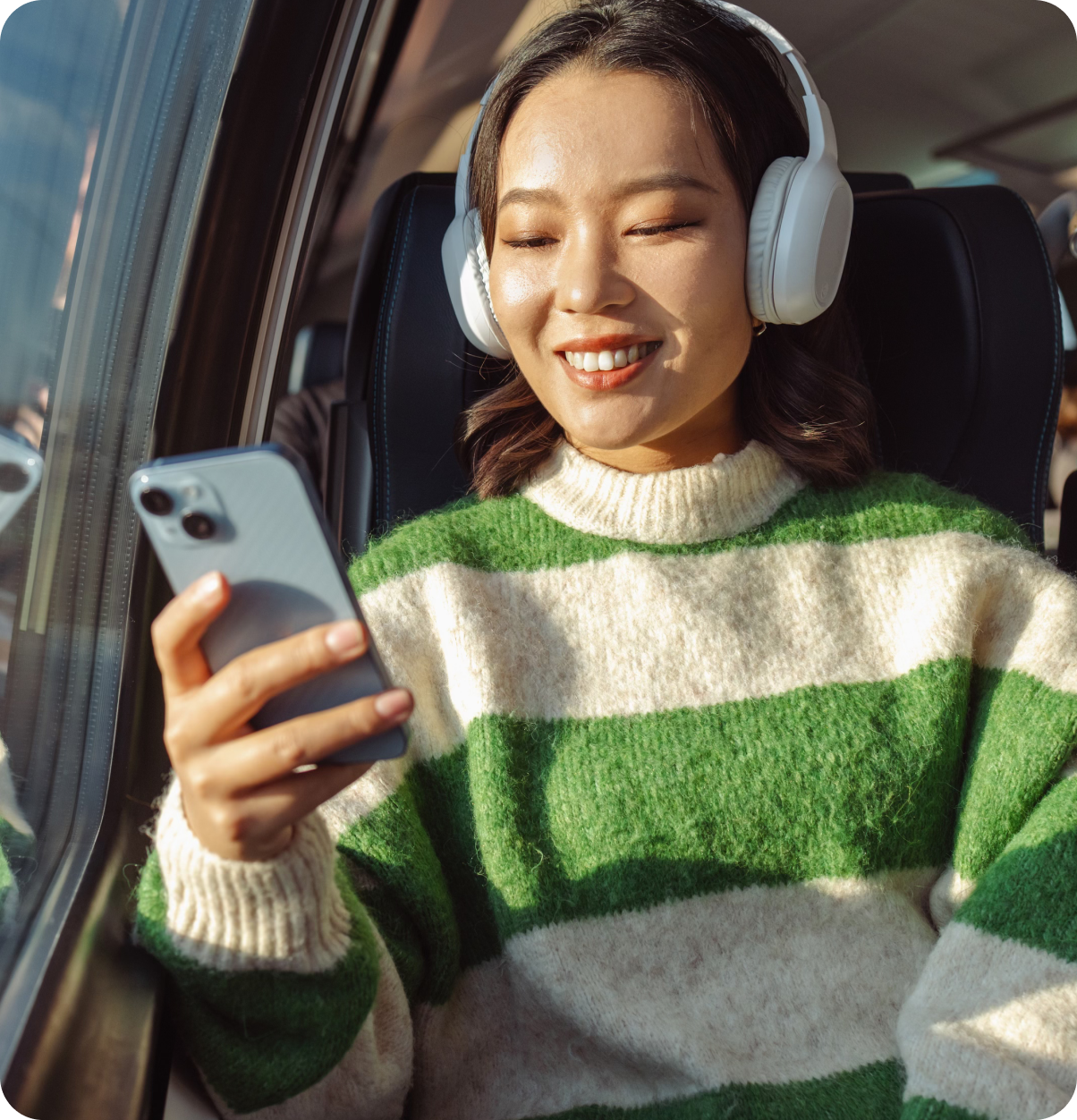 Woman smiling on phone while on bus.