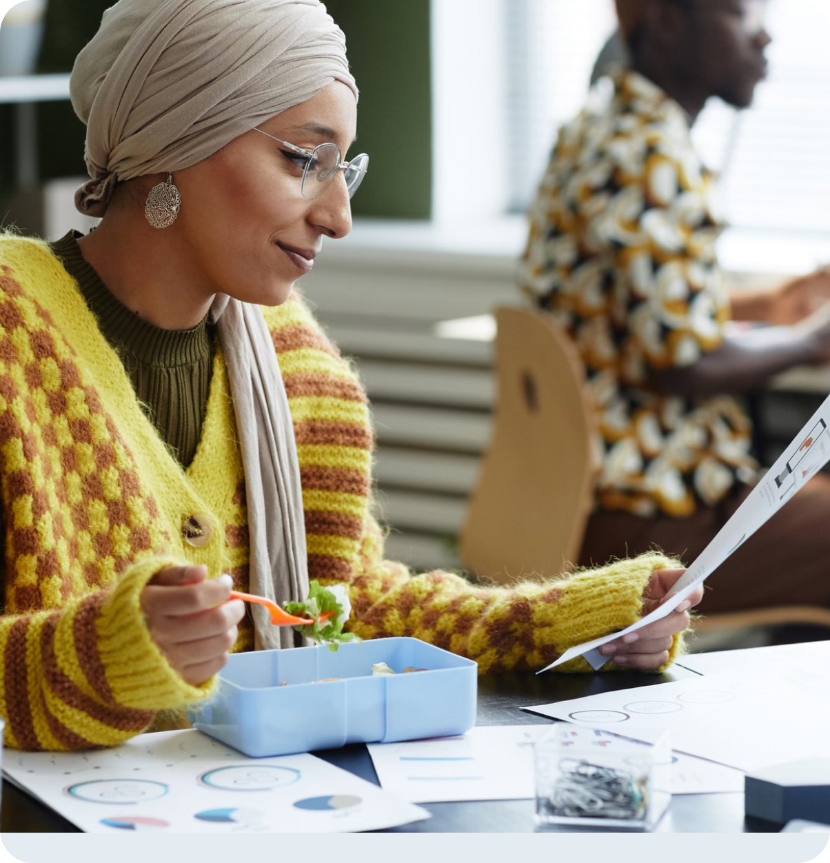 Older adult reads mail during lunch.