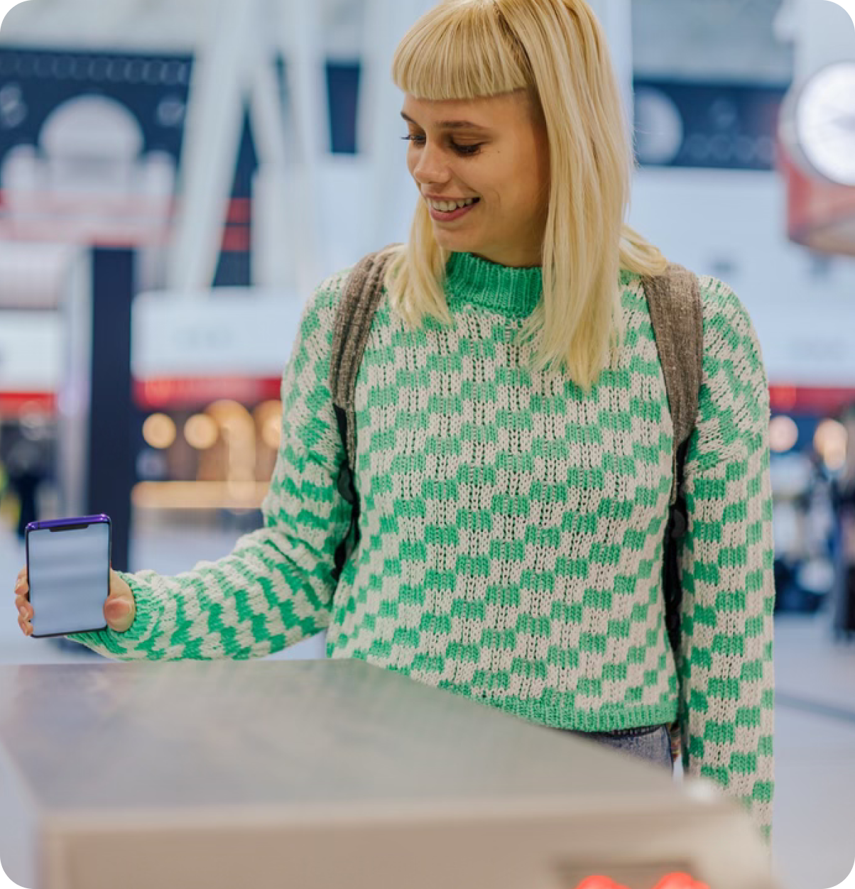 Smiling woman pays by phone.