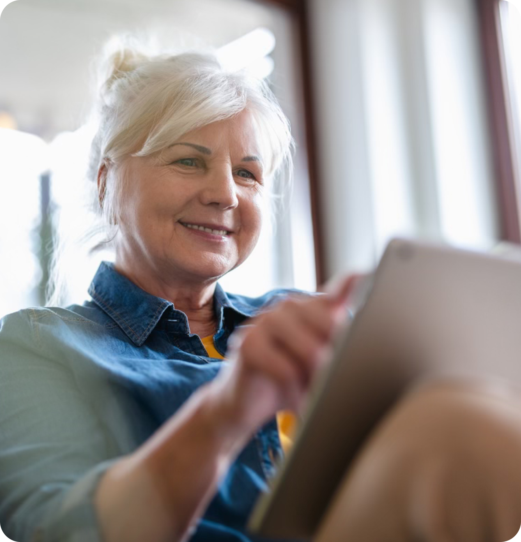 Senior navigates tablet.