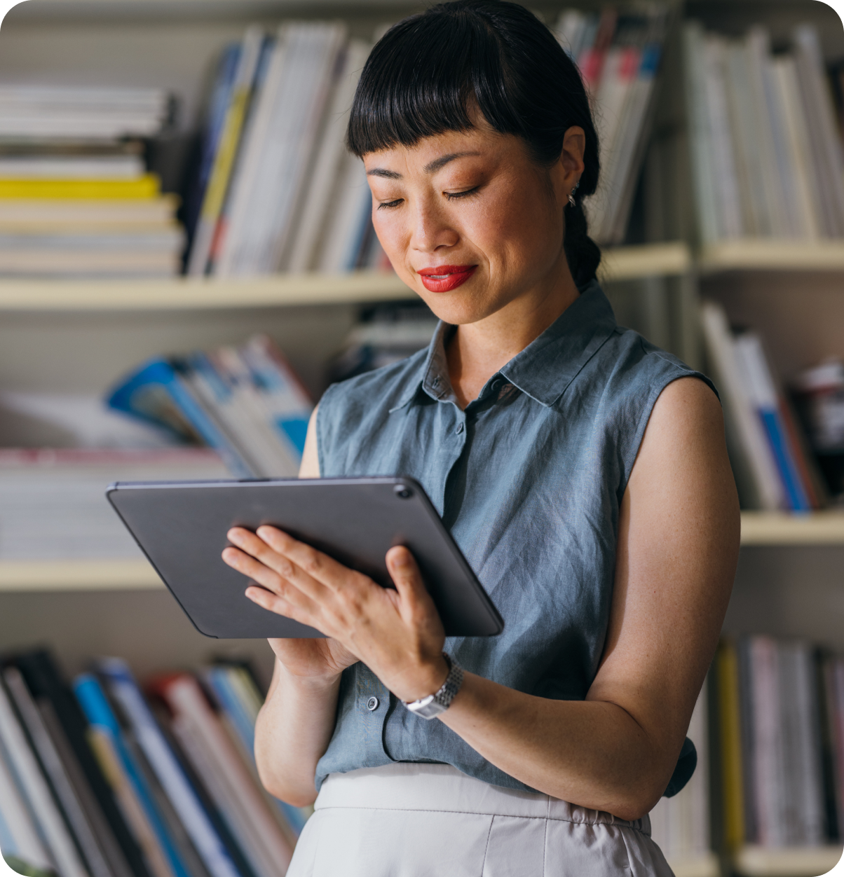 Woman standing using tablet.