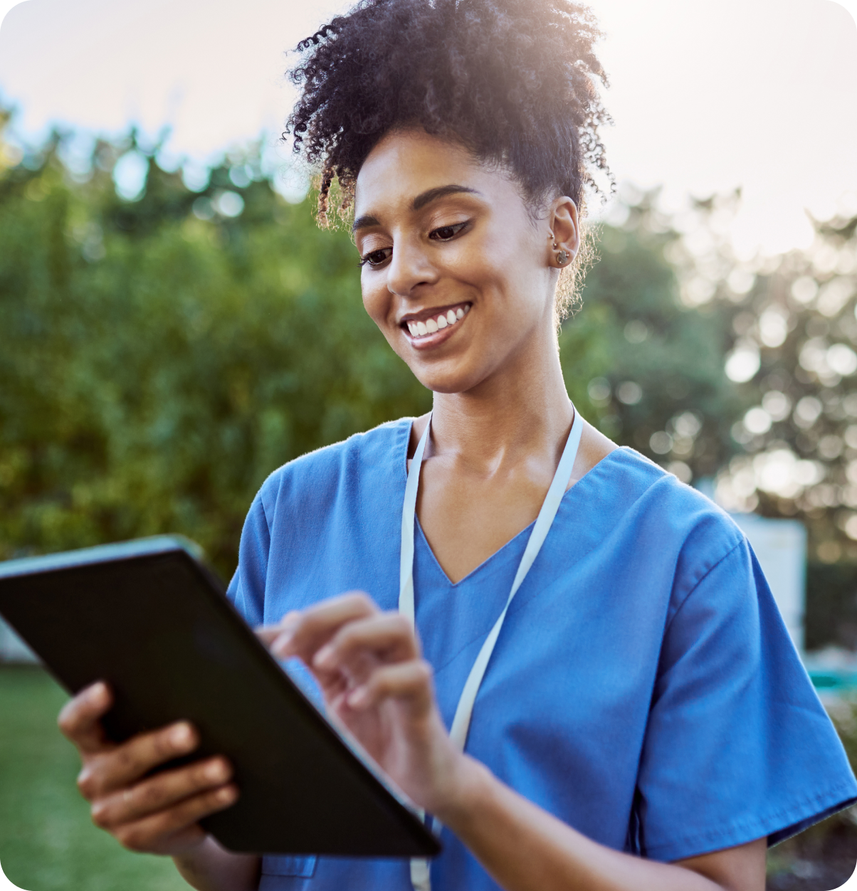 Female health care worker using tablet.